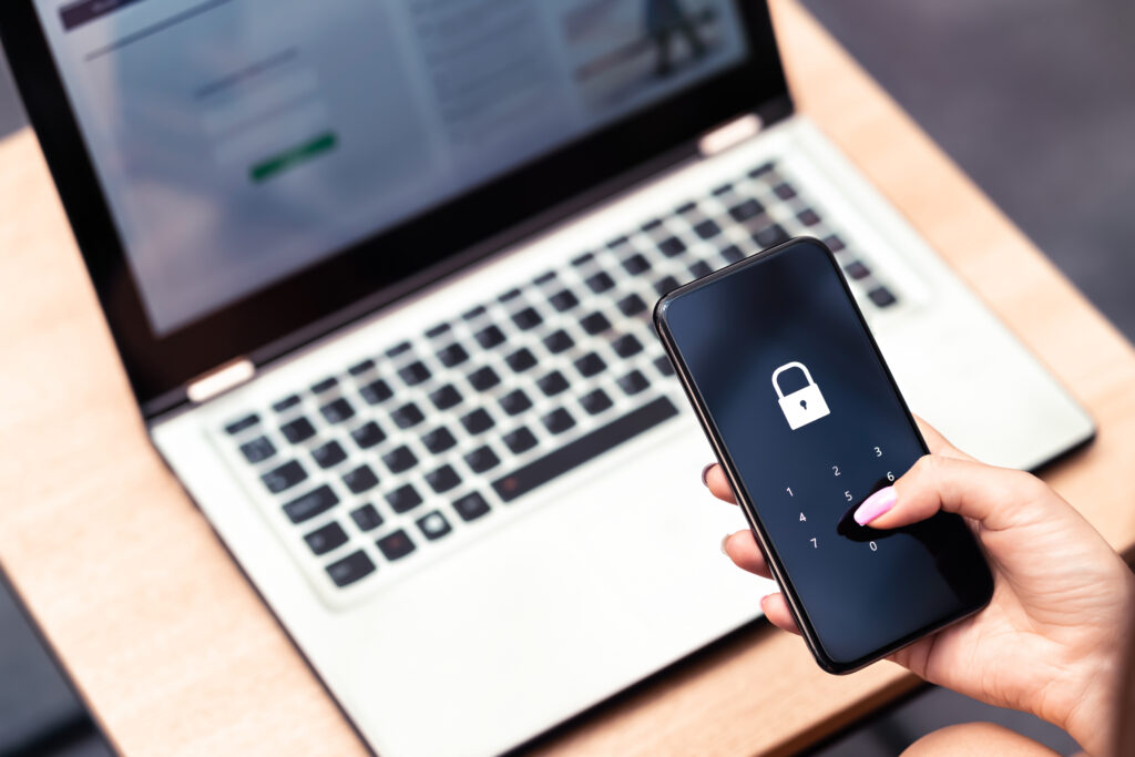 Phone password lock for mobile cyber security or login verification passcode in online bank app. Data privacy and protection from hacker, identity thief or cybersecurity threat. Laptop and smartphone.